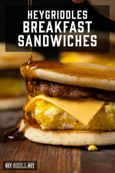 a cheeseburger with the words heygriddles breakfast sandwiches on it's side