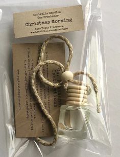 a small glass bottle with a rope wrapped around it on top of a piece of paper