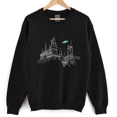 a black sweatshirt with an image of hogwarts castle on it