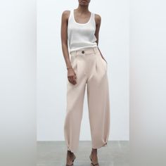 Beautiful European Style Pants Carrot Fit Trousers With Darts Detail Mid-Waist Belt Loops Side Pockets And Rear Welt Pockets Dark Detail On The Front Pleated Hem With Contrast Button.Front Zip And Bottom Fastening Viscose Blend Zara Cotton Pants, Carrot Pants Outfit, Pleated Tapered Pants, Carrot Pants, Zara Trousers, Feminine Wardrobe, Zara Jumpsuit, Wide Trousers, Chic Blouses