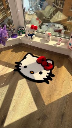 a hello kitty rug in front of a window