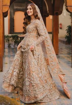 a woman in a bridal gown posing for the camera