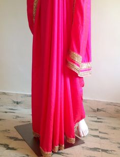 "Gorgeous glowing pink semi silk saree with a beautiful stone work border and silk unstitched blouse in blue silk brocade. The blue brocade is simply stunning when paired with the hot pink saree. Saree length 5.5 meters Blouse fabric 1 meter 44\" wide Saree ships in 2-3 days of payment.Shipping time is 4-5 days with tracking. We also offer blouse and petticoat stitching for saree as additional services. Please convo me if you need help or have any questions." Pink Raw Silk Pre-draped Saree With Dupatta, Pink Raw Silk Pre-draped Saree With Resham Embroidery, Pink Raw Silk Bollywood Salwar Kameez, Pink Bollywood Raw Silk Salwar Kameez, Pink Raw Silk Anarkali Traditional Wear, Pink Anarkali Traditional Wear In Raw Silk, Designer Pink Pre-draped Saree With Zari Work, Traditional Pink Pre-draped Saree With Embroidered Border, Pink Silk Traditional Wear With Dabka Work