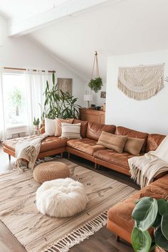 a living room filled with lots of furniture and plants on top of a rug in front of a window