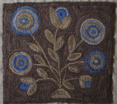 a brown and blue rug with flowers on it