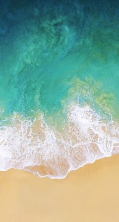 an aerial view of the ocean and beach