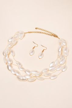 Elevate your look with this stunning pearl necklace and earring set. The perfect blend of classic and modern, this set features large oval-shaped pearls in a trendy design. Made with high-quality materials, it's perfect for any occasion. Dress it up or down, this set is sure to become a staple in your wardrobe. Add a touch of elegance to your look with this pearl set. SizeLength: 19 in (48.26 cm)Ext: 2.5 in (6.35 cm)D: 1.5 in (3.81 cm)E: 1.5 in (3.81 cm) Quality Made with acrylic pearl beads and Elegant Oval Bead Pearl Jewelry, Elegant Pearl Jewelry With Oval Beads, Elegant Oval Beads Jewelry For Party, Elegant Oval Bead Party Jewelry, Layered Oval, Pearl Necklace And Earring Set, Pearl Necklace Earrings, Baroque Pearl Necklace, Necklace And Earring Set