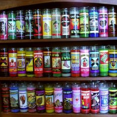 a wooden shelf filled with lots of different types of spices