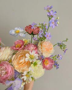 a vase filled with lots of different colored flowers