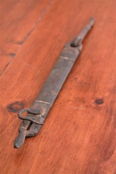 an old metal latch on top of a wooden table