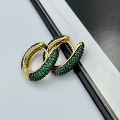 These beautiful and trendy emerald green huggie hoop earrings will make an excellent gift for yourself or friends. 18K real gold plated over brass, emerald green colored Cubic Zirconia. Measurements: Outer diameter - 17 mm Inner diameter - 10 mm These earrings would be a PERFECT GIFT for you and your family and friends! Our jewelry comes beautifully packaged in a gift box!   Click here to see more Modern Everyday Earrings: https://etsy.me/2UJldl1 Thank you for your visit! Emerald Green CZ Huggie Cheap Statement Green Hoop Earrings, Green Emerald Hoop Earrings, Elegant Green Hoop Earrings, Emerald Hoop Earrings Gift, Green Huggie Earrings With Matching Set, Elegant Green Hoop Huggie Earrings, Elegant Green Huggie Hoop Earrings, Small Hoop Emerald Earrings In Green, Elegant Green Small Hoop Huggie Earrings