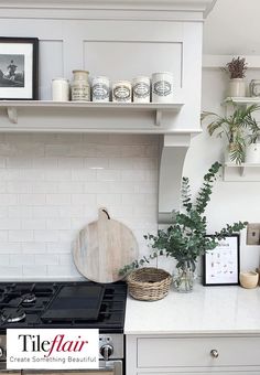 a kitchen with white cabinets and shelves filled with pots and pans on the stove