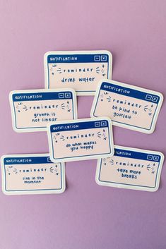 four identification tags on a purple surface with white and blue writing in the bottom right corner