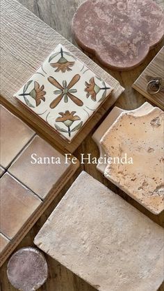 several different types of tile sitting on top of a wooden table