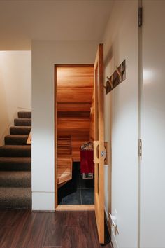 an open door leading to a wooden staircase