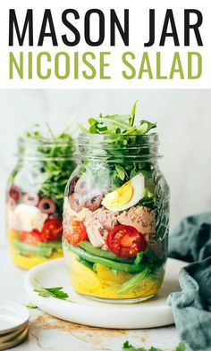 two mason jars filled with salad on top of a white plate and text overlay reads mason jar nicose salad