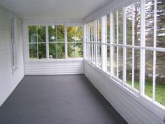 an empty room with large windows on both sides