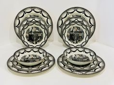 three black and white plates with boats on them