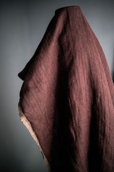 a dark brown blanket hanging on the wall