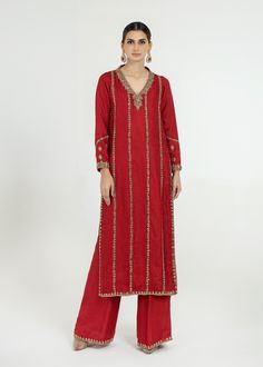 Adorn Yourself In This Crimson Red Pure Jamawar Long Shirt All Handworked With Dabka, Resham, Nakshi, Zardozi And Mirrorwork Details (Fully Worked Front And Back) Paired With Matching Wide-legged Pants With Matching Work On The Bottom. (Includes Shirt And Pants) Red Raw Silk Kurta With Dori Work, Red Kurta For Reception In Transitional Season, Festive Red Raw Silk Kurta, Transitional Red Raw Silk Sets, Transitional Season Red Raw Silk Sets, Red Kurta With Gota Work For Celebration, Red Kurta For Festive Reception, Red Palazzo Set For Navratri Celebration, Red Palazzo Set With Resham Embroidery For Celebration