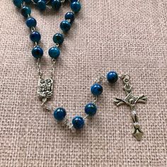 "Catholic Rosary Beads Necklace. Made and blessed in Jerusalem Holy Land Bead color: navy / multicolor Cross color - silver tone Drop length - Approximately 22\"-22.4\" ( 56-57 cm ). Approximate crucifix size -1.75\"x1\" Comes in a pouch as pictured. Silver tone metal Catholic Crucifix Cross with beautiful double sided center piece. If you have any questions, feel free to ask us. We are based in Florida and ship packages every business day very Fast and absolutely FREE! God Bless You and Your Fa Rosary Beads Necklace, Catholic Crucifix, Rosary Beads Catholic, Catholic Rosary, Rosary Catholic, Rosary Beads, Holy Land, Beads Necklace, Blue Beads