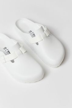 The classic Boston clog by Birkenstock gets a lightweight EVA update. Features a closed toe clog silhouette with an adjustable strap & buckle. Finished with textured tread at the outsole. Features Lightweight EVA clogs from Birkenstock Updated Birkenstock Boston silhouette Textured outsole Easy slip-on style Content + Care EVA Spot clean Imported | Birkenstock Boston EVA Clog in White, Women's at Urban Outfitters Comfortable Synthetic Clogs With Buckle Closure, Synthetic Round Toe Clogs With Buckle Closure, Closed Toe Synthetic Clogs With Buckle Closure, Synthetic Closed Toe Clogs With Buckle Closure, White Slip-on Clogs With Textured Footbed, Waterproof White Clogs With Round Toe, White Waterproof Clogs With Round Toe, White Waterproof Synthetic Clogs, Waterproof White Synthetic Clogs