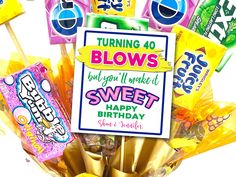 a bunch of candy sticks with a sign saying turning 60 blows get you'll make it sweet happy birthday