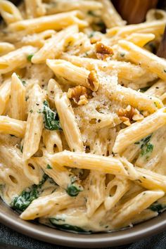 pasta with spinach and parmesan cheese in a bowl