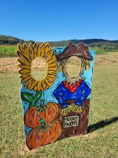 a scarecrow with sunflowers and pumpkins on it