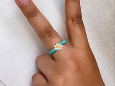 Daisy flower Ring Choose from S / M / L Choose your flower color and your center color too! You will receive (1) one ring ✨About Me✨ Hi! My name is Jordi, I'm 13 years old and I've been creating beaded jewelry for a year now. Thank you for stopping by and checking out my jewelry.  ✨Shipping✨ I will ship your order within 3-5 days, I try to get them out as soon as possible :).  ✨Shop Policies✨  All sales are final, every order is made to order and fit the buyer. Thank you for taking the time to check out my items, if you have any questions, please message me, I respond to messages daily.  with love, -jordi Adjustable Flower Ring For Summer, Trendy Adjustable Flower Ring, Trendy Flower Shaped Ring For Gift, Multicolor Adjustable Flower Ring, Ring Y2k, Colorful Rings, Jewelry Colorful, Daisy Jewelry, Rings Handmade