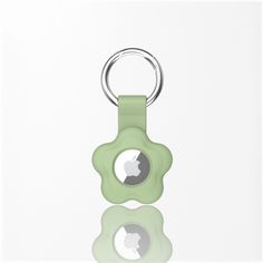 an apple keychain is shown in front of a white background with reflective reflection