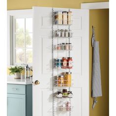 the pantry door is open to reveal an organized pantry