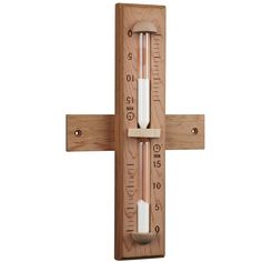 a thermometer mounted to a wooden cross on a white background with clippings