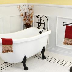 a white bath tub sitting next to a black faucet