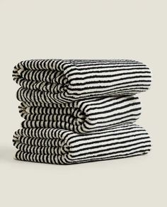 black and white striped towels stacked on top of each other