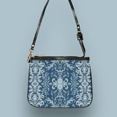 This unique and vibrant shoulder bag adds a chic touch to any outfit. Its compact size (10"w x 8"h) and lightweight construction makes it the perfect accessory for carrying around your essentials in style. Our one of a kind purse features an archival fabric design in baroque flourishes of sapphire, sky and pale blues. This gorgeous design is printed onto high-grade vegan leather and shipped to you by our top-rated production partner. We also offer the coordinating vegan wallet: https://thecheekyshedonist.etsy.com/listing/1680599038 .: 100% high-grade vegan leather exterior .: Polyester lining + 20-inch black strap .: Two open pockets inside .: Gold-toned zipper and hardware .: Original + unique art history design exclusively available at The Cheeky Shedonist  Care instructions: avoid prolo Vegan Wallet, History Design, Gorgeous Design, Top Rated, Art History, Unique Art, High Grade, Inside Pocket, Purses And Handbags