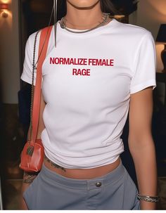 ⚡️Normalize Female Rage" Brat-Style Tee⚡️ 💚 Unapologetic and powerful. This minimalist brat style indie tee makes a bold statement--embrace and Normalize Female Rage. Simple, fierce, and straight to the point. Brat style statement tee, funny y2k style tee, Indie 2.0 💅 Exclusively designed by Emotional Trance. 🌿 This tee is made with 100% cotton, ethically grown & harvested in the USA ✊ We are members of the US Cotton Trust Protocol ensuring ethical and sustainable means of production 🕯️ Baby Fitted Streetwear T-shirt With Screen Print, 90s Style Stretch Crew Neck T-shirt, 90s Fitted T-shirt With Funny Text, 90s Style Short Sleeve T-shirt With Funny Text, Fitted Basic T-shirt With Slogan, 90s Style Stretch T-shirt With Short Sleeves, Y2k Style White T-shirt With Short Sleeves, Y2k Style White Short Sleeve T-shirt, White Y2k Short Sleeve T-shirt