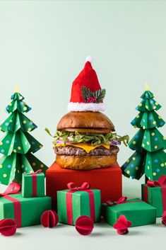 a large hamburger sitting on top of a pile of presents