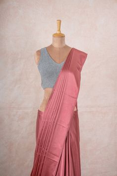 This versatile saree is perfect for any occasion, be it formal or casual, and ensures all-day comfort while exuding elegance. Fabric Content: Satin Silk Color: Champagne Pink Saree Size: 5.7 metres Display: The Model is draped in our Rosalia satin saree with our shimmer grey Blouse Styling: The saree can be paired with our Gold Buff Shaper,  Grey glitter blouse or Shimmer grey blouse. Colors Available: 6  Notes: The edges of the saree are finished. Pink Satin Saree, Blouse Styling, Satin Sarees, Saree Fancy, Glitter Blouse, Champagne Pink, Sarees For Women, Rose Champagne, Silk Thread Bangles