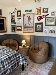 a bed room with a neatly made bed and pictures on the wall