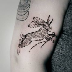 a woman's arm with a tattoo of a rabbit on the left side of her body