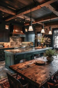 a large kitchen with an island and wooden table in the center, surrounded by chairs