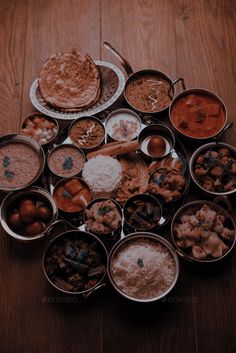 a table topped with lots of different types of food on top of metal pans