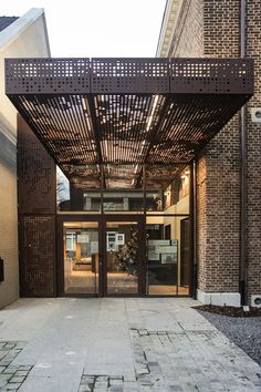 an entrance to a building with a pergolated roof