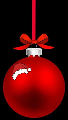 a red ornament with a santa hat hanging from it's side on a black background