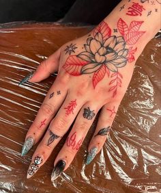 a woman's hand with tattoos on it