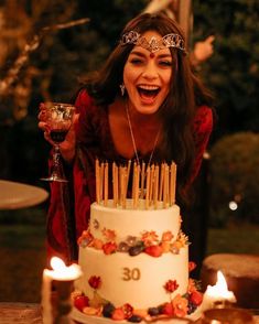 an image of a woman celebrating her 30th birthday with candles in front of her cake