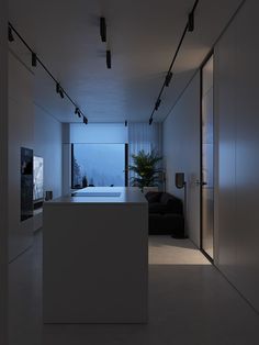 an empty kitchen and living room are lit up at night