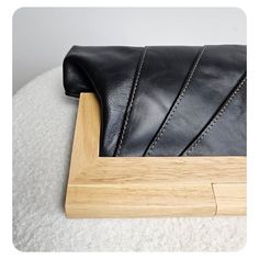 The combination of leather and timber in these clutches indeed creates a beautiful and harmonious design. The clutches are made with exquisite, smooth, and high-quality leather sourced from New Zealand. The use of this premium leather ensures durability and a luxurious feel to the touch, enhancing the overall aesthetic of the clutch. The natural timber handle not only adds a unique and organic element but also provides a functional magnetic closure to securely keep the contents of your purse safe. The magnetic closure ensures easy access while providing peace of mind that your belongings are secure. To add further interest, the clutches are lined with printed cotton lining. Please note that the actual lining may vary from the picture, adding a delightful surprise and making each clutch uni Chic Rectangular Clutch With Leather Lining, Smooth Grain Leather Clutch For Evening, Leather Clutch With Smooth Grain For Evening, Leather Pouch Clutch With Leather Handles, Evening Leather Clutch With Smooth Grain, Rectangular Smooth Grain Clutch For Evening, Modern Rectangular Clutch With Leather Lining, Rectangular Clutch With Smooth Grain For Evening, Rectangular Evening Clutch With Smooth Grain