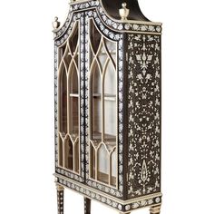 an ornate display cabinet with glass doors and metal trimmings on the top shelf